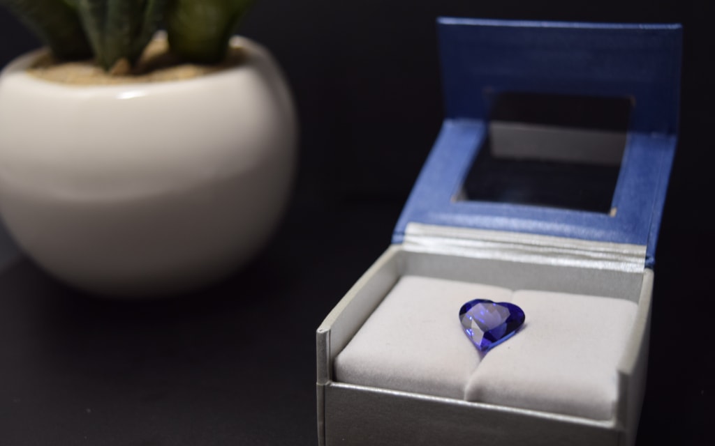 Blue tanzanite gemstone presented in a box case