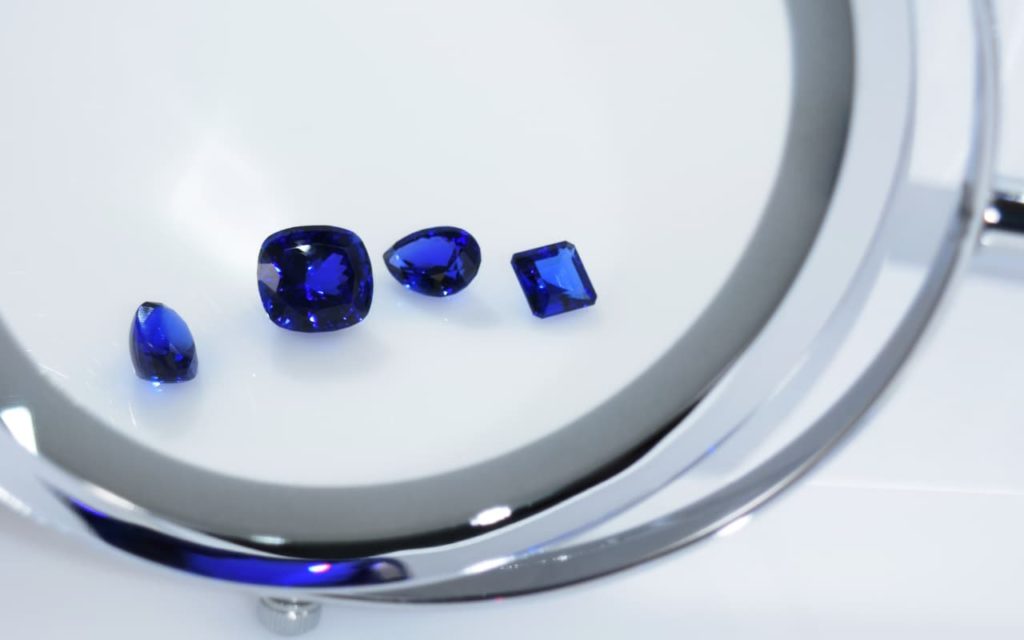 Tanzanite stones under a magnifying glass
