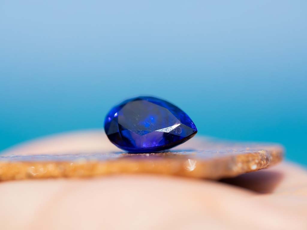 Price tag beside a natural Tanzanite stone indicating current market value
